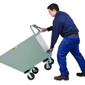 A person in a blue shirt and jeans tips the Little Giant Hopper Truck with Ergonomic Handle. The gray industrial cart, with four wheels, is tilted forward, indicating use for transporting or dumping materials against a white background.