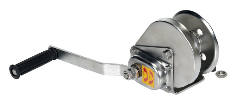 A manual boat trailer winch like the Vestil Stainless Steel Winch 1200 Lbs, with a black handle and metal body, includes a gear mechanism and two pulley wheels for rope or cable operation; a small sticker is visible on the side.