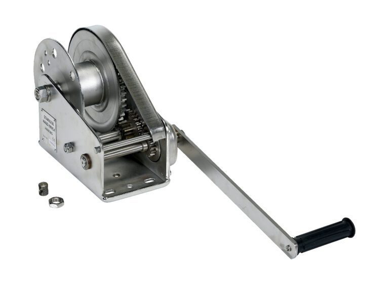 The Vestil Stainless Steel Winch 2600 Lbs offers a durable design with a black-handled crank and exposed gears, boasting a 2600 lb capacity. It includes a winding spool and two metal rings, set against a white background.