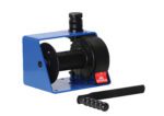 The Vestil Hand Winch - Vertical Handle Worm Gear has a blue hoist, black drum, and vertical handle. It handles 500kg loads with a worm gear mechanism and ribbed handle for secure grip and efficient pulling.