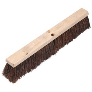 The MH-USA Garage Broom Head - 24 is a wooden push broom with dark, fanned-out bristles, designed for sweeping large areas. It features a sturdy build and two holes for easy handle attachment, making it ideal for garage cleanup tasks.