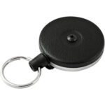 The Heavy Duty Original KeyBak® Retractable Key Holder, featuring a round black design with a textured pattern, metal keyring, and a central screw, is available in a 2 Pack (2/Case).