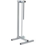 The MH-USA 27 Vertical Roll Paper Cutter boasts a sleek design similar to the silver metal bike repair stand, both having vertical support. The bike stand also features a top clamp and a wide-leg base for stability.