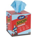 A box of Scott® Blue Shop Towels Pop-Up® 200 Towel Box (2 Pack) features a person in work attire beside the American flag on a red and blue design, with a blue towel partially pulled out from the top.