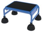 A blue step stool, similar to the Vestil Spring Loaded Roll Ladder 1 Step Blue, has a textured black surface, four black suction cup feet, and a flat platform on a robust metal frame.