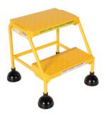 A yellow two-step safety stool, similar to the Vestil Spring Loaded Roll Ladder Perf 2 Stp Yel, features black rubber feet and a top step with SAFETY FIRST SEGURIDAD PRIMERO in bold black text for stability and easy access to high areas.