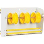 The MH-USA 12 1/2 Wall Mount Label Dispenser, white and industrial in design, features three large yellow spools on metal rods and two extra rods below.
