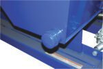 A close-up of a blue metal apparatus resembling the Vestil Hopper - Leak Proof Option, featuring a protruding knob on one side. Set against a similar blue frame, its glossy, newly painted surface also reveals a coiled metal spring partially visible to the right.