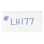 A white paper with #LH177 in blue marker evokes the simplicity and functionality of MH-USA 2 x 4 White Warehouse Labels - Magnetic Strips (25/Case).