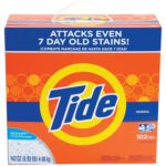 The Tide® High Efficiency Powder Detergent - 143 oz. Box (2/Case) effectively tackles tough stains, even 7 days old, with Acti-Lift Crystals in vibrant blue and orange packaging, ensuring powerful cleaning for 102 loads with its English and Spanish slogan.