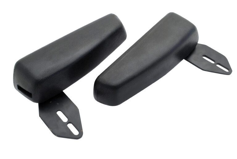 Two black car bumper guards, each with two-slot metal brackets for attachment, have angled edges. Their textured surface reflects the durability of a Vestil Truck Seat Option - Flip Up Arm Rests. They sit parallel to each other, one slightly tilted.