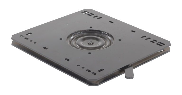 LTS-ET_A.jpg A sleek, square metal swivel plate with slots and holes sits elegantly on a white background. It has a central circular indentation and lever, making it perfect for the Vestil Truck Seat Option - Swivel Platform.