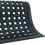 The MH-USA 3 x 5 Slip Guard Drainage Mat, with raised interlocking patterns and large circular holes, has smooth, slightly curved edges. Against a white background at an angle, it perfectly blends functionality with style.