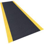 The MH-USA 3 x 8 Black/Yellow Anti-Fatigue Mat features a textured black surface for traction and bright yellow edges for visibility, making it a safe anti-slip floor accessory against the plain white background where its showcased.
