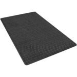 The MH-USA 3 x 5 Charcoal Deluxe Entry Mat boasts a rectangular, dark gray design with a ribbed texture. Photographed at an angle, its thin profile and minimalist style elegantly contrast against a white background.