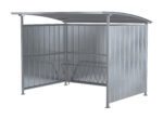 The Vestil Galvanized Multi-Duty Bicycle Shelter 120 In features a freestanding metal design with a curved roof and three vertical metal panel walls; it includes an attached bike rack, providing open-sided shelter and convenience.