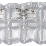 The sheet of 6 x 7 MINI PAKR™ Double Cushion Pillow (656/Roll) air pillows, designed for packaging, features visible seams and recycling symbols on its transparent surface for protection during shipping.