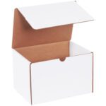 An empty MH-USA 9 x 6.5 x 6 white literature mailer, part of a 50/bundle set, sits open with its flaps up and a semi-circular notch on the front edge. Its brown interior is visible against a plain background.
