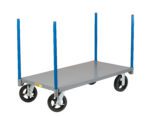 The Little Giant Pipe Stake Truck is a gray, flat, rectangular platform cart featuring four large black wheels and four upright blue corner poles, designed for easy item transport.