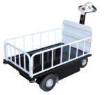 The Vestil Traction Drive Cart Top Load W/ Gate features a black platform and white railings for easy maneuverability with four-wheel mobility. Its control-button steering handle simplifies transporting goods, making it ideal for warehouses or airports, and includes a secure gate.