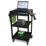 A black rolling utility cart with three shelves. The top shelf holds a laptop with graphs on the screen and a keyboard. The middle shelf has a label printer, and the bottom shelf contains a boxed device. A barcode scanner is attached to the side.