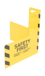 A portable 24x24-inch yellow steel safety sign with black diagonal stripes, featuring SAFETY FIRST, SEGURIDAD PRIMERO, and LA SÉCURITÉ DABORD. Similar to the Vestil Plate Corner Guard W/Handle Steel 24 X 24 In.