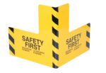The Vestil Plate Corner Guard, measuring 24 x 24 inches, is yellow with black diagonal stripes and SAFETY FIRST in English, Spanish, and French. It is expertly designed to fit any surface edge, emphasizing safety.