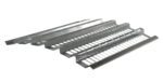 Vestil Open-Area Pallet Rack Decking, 38.5 X 108, with ridged surfaces and narrow openings, is stacked diagonally on a white background.