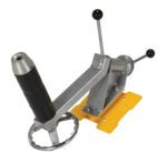 A metal ships wheel and throttle control mechanism akin to the Vestil Quick Lift Reel Rotator Attachment. It has a yellow base, a four-spoke wheel, and a throttle with two black handles, all seemingly crafted for marine utility.