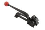 The Vestil Steel Tensioner .375 to .75 Strapping comes in a black finish. Its long handle, featuring a red spherical grip, is angled diagonally to highlight its textured surface and durable metal gears for precise tensioning and cutting.