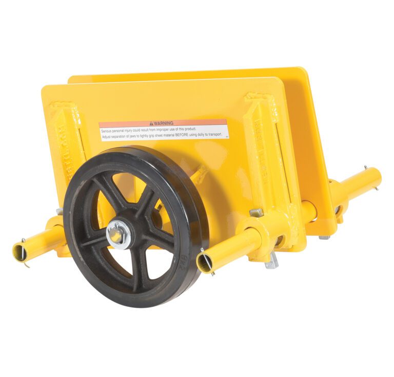 A yellow machinery component similar to the Vestil Adj Panel Dolly 1K Mold On Rubber has a large black wheel, two flat plates, cylindrical extensions on both sides, and a warning label on the rubber surface, indicating its use in industrial or mechanical equipment.