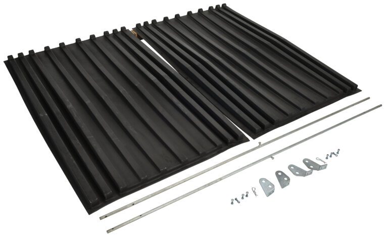 Two black plastic ramps with grooved surfaces for traction are laid side by side, assembly hardware, screws, and brackets like those on a Vestil Poly Lid For Size 3 Style D Hopper placed in front.