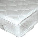 A white mattress adorned with a quilted floral pattern is snugly wrapped in MH-USA 60 x 9 x 92 - 1.1 Mil Mattress Bags (125/Roll). The glossy protective plastic showcases its slightly raised top, revealing the edge beneath.