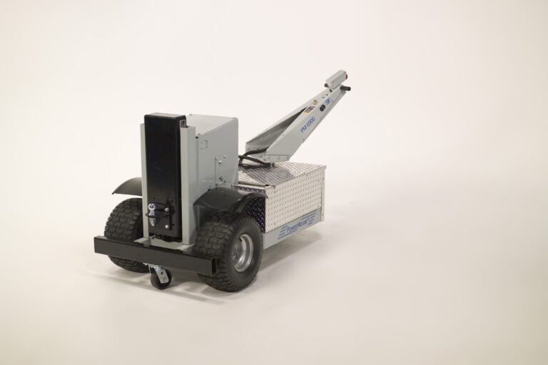 PMM-3000_A.jpg The Vestil Power Move Master 3K 78 X 36 X 43 showcases large rugged wheels and a metal box-like design, with an articulated arm extending from the top for industrial applications, set against a plain white background that highlights its technical components.