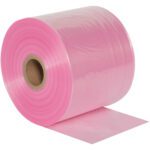 A large roll of MH-USA 8 x 2150 - 2 Mil Anti-Static Poly Tubing is partially unrolled, showcasing its smooth, shiny pink surface with a visible cardboard core in the center.