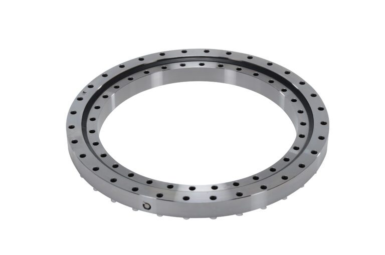 The Vestil Precision Turrent Bearing 24.25 In is a large, circular bearing with a silver metallic finish featuring multiple evenly spaced holes on its inner and outer edges for mounting, standing out against the plain white background with its sleek design.