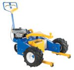 The Vestil Gas Powered Trailer Mover 12K is a blue and yellow industrial cart equipped with large black tires, a handlebar, and a side-mounted small engine, making it a heavy-duty powerhouse designed for tough tasks.