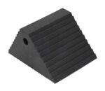 The Vestil Plastic Dual Slope Wheel Chock in black has a triangular design with a textured surface, features horizontal grooves on top, and includes a side circular hole for convenience.