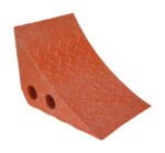 The Vestil Recycled Orange Plastic Wheel Chock, made of textured rubber, prevents vehicle movement with its sloped shape. It offers two handling holes for easy use, ensuring durability and convenience in a compact design.