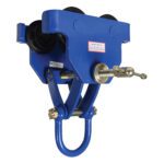 The Vestil Manual Trolley 12000 Lb Capacity boasts a blue industrial frame, black wheels, and a silver adjustment screw. Designed for heavy-duty use, its durable metal design features the model number on a small label.