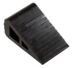 The Vestil Industrial Rubber Wedge 6.5 X 4 is a black rubber chock with a ribbed, wedge shape designed for stability and movement prevention, featuring hollow sections for lighter weight and easy handling.