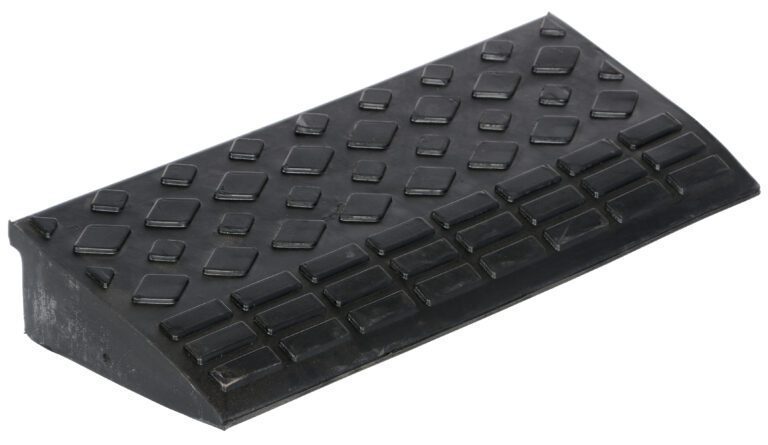 The Vestil Hd Rectangular Rubber Ramp 23.625 Wide includes a black plastic wheel chock with a textured, non-slip surface and angled ramp design. Its diamond-shaped patterns enhance grip to effectively prevent vehicle movement.