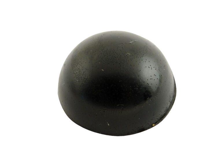 A sleek, black dome-shaped item, similar to the Vestil Rounded Rubber Dome Bumpers 1.25X1.25 In, stands boldly against a pristine white background.