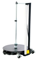 The Vestil Roll Material Portable Dolly W/Cutter is a vertical cylinder with a wheeled black base, metal rod, bars, and a central gear-like cutter, enhancing its practicality for various tasks.