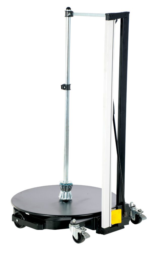 ROLL-D-DLX_A.jpg The Vestil Roll Material Portable Dolly W/Cutter is a vertical cylinder with a wheeled black base, metal rod, bars, and a central gear-like cutter, enhancing its practicality for various tasks.