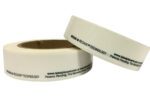 Two white tape rolls featuring HOLD & RELEASE TECHNOLOGY and a website URL are displayed, with one roll upright and the other leaning. This arrangement mirrors the efficient organization provided by Vestil Economy Racking Labels 1 In 100 Rolls.