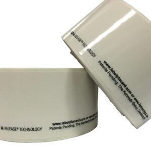 Two large rolls of Vestil Economy Racking Labels 2 In 25 Rolls feature printed text around the core, showcasing website info, trademarks, and Hold & Release technology. The labels are positioned to display both side and top views.