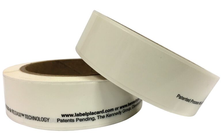 Two rolls of white adhesive tape at angles—one standing upright, the other leaning sideways—feature black text along the bottom edge, resembling labels for Vestil Industrial Racking Labels 1 In 5 Pcs, ideal for any workspace setup.