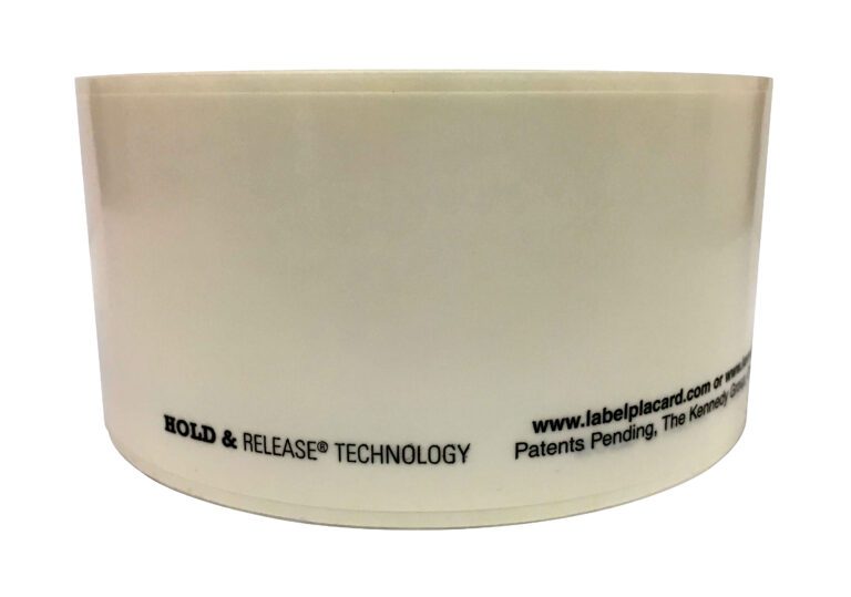 A partially unrolled roll of clear adhesive tape featuring HOLD & RELEASE TECHNOLOGY, a website URL, and Patents Pending printed along the bottom edge sits on a white background, ideal for labeling tasks like those using Vestil Industrial Racking Labels.