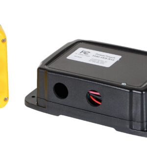 A black rectangular electronic device with a label and wires is next to the yellow Vestil Radio Remote Control 2 Button, a handheld remote used for efficient industrial equipment management.